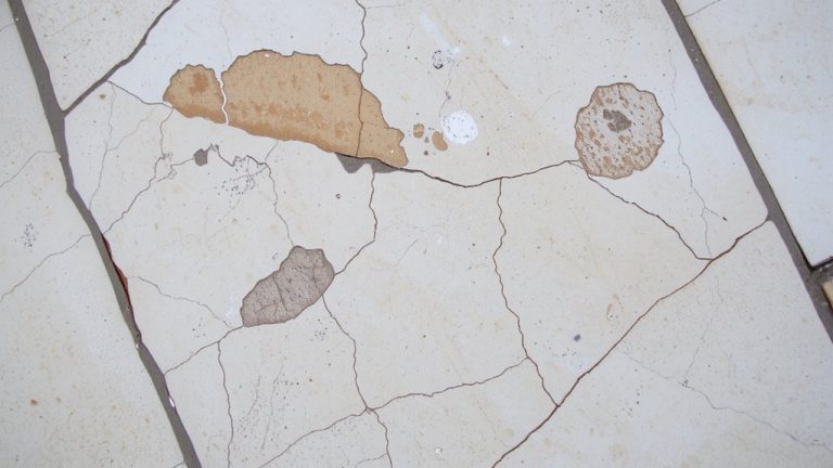 corrosive damage to grout and stone
